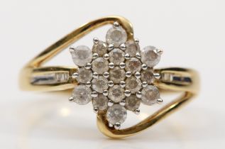 A 9ct gold brilliant cut diamond floral cluster ring, with baguette cut diamonds to the shoulders,