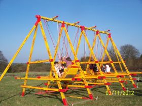 A set of four Vintage Edwardian Fairground Swingboats, painted predominantly yellow, believed to