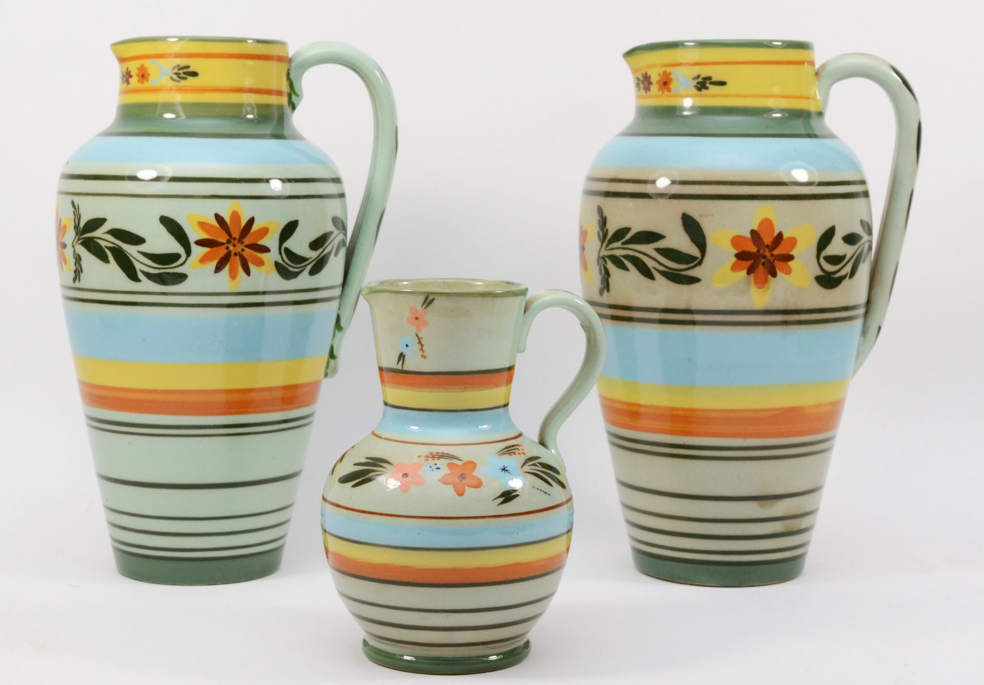 Castleford Pottery; three 20th century painted and glazed jugs decorated in the Peasant pattern, - Image 2 of 5