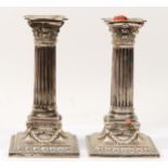 An Edwardian silver pair of Corinthian column candlesticks, London 1903, with acanthus leaf