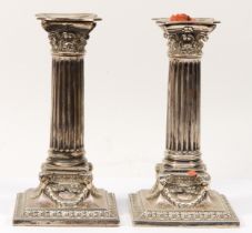 An Edwardian silver pair of Corinthian column candlesticks, London 1903, with acanthus leaf