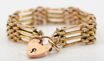 A Victorian 9ct gold gate link bracelet with heart shaped padlock clasp, safety chain, 18cm, 16.3gm.