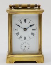 A French brass corniche cased hourly striking carriage clock, movement striking on a bell, the white