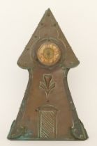 An Arts & Crafts period hammered copper cased architectural tower mantle clock, raised on plinth