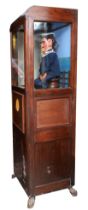 Laughing sailor, HMS Happy, by Modern Enterprises, stained oak cabinet, raised on cast metal feet,