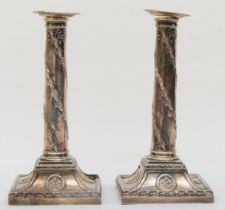 A silver pair of candlesticks, by Barnard & Sons, London 1912, the tapering columns with spiral