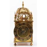 A brass lantern clock, early 20th century, striking on a bell, with pierced fretwork decoration, the