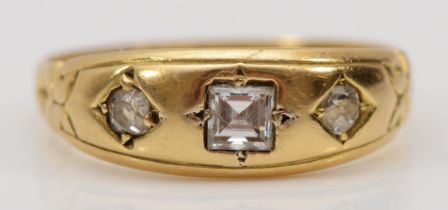 A Victorian three stone diamond gypsy ring, replacement square cut central diamond flanked by two