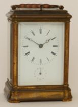 An early 20th century hourly repeater striking brass corniche cased carriage clock, striking on a