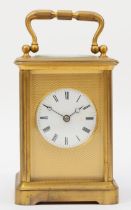 A 20th century brass corniche cased striking carriage clock, striking on the half hour, with applied