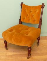 A 19th century mahogany framed button back nursing chair, raised on tapering fluted supports