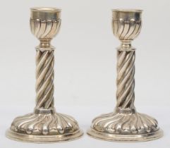 A pair of Victorian silver candle sticks, makers mark rubbed, London 1893, with embossed bases,