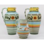 Castleford Pottery; three 20th century painted and glazed jugs decorated in the Peasant pattern,