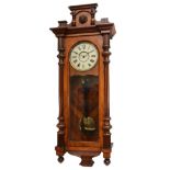 A walnut veneered Vienna style wall clock, late 19th century, the cornice mounted with the head of a