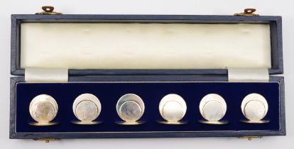 A silver set of six circular menu holders, by Harrods, London 1990, base 28mm, 78gm, case