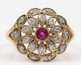 A vintage gold ruby and brilliant cut diamond floral dress ring, P-Q, unmarked, 3.8gm.