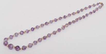 A 9k gold clasped graduated faceted amethyst bead and paste necklace, 5 - 11mm beads, 57cm.