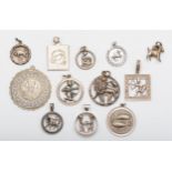 A group of silver zodiac pendants and charms to include an Aries charm, 14mm, 36gm.
