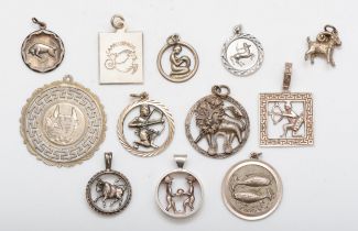 A group of silver zodiac pendants and charms to include an Aries charm, 14mm, 36gm.