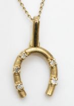 A 375 gold brilliant cut diamond horseshoe pendant, 20mm, on a unmarked gold chain, 1.5gm.