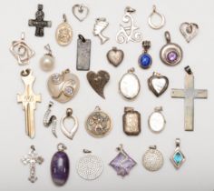 A group of silver pendants and lockets to include a Victorian silver crucifix, by B&W, Birmingham