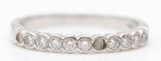 A platinum brilliant cut diamond half eternity ring, N, 3.1gm, one stone broken.