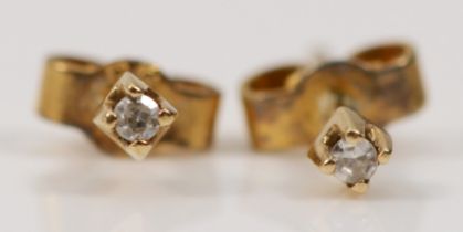 A pair of eight cut diamond stud earrings, with rolled gold butterfly backs, 2mm.
