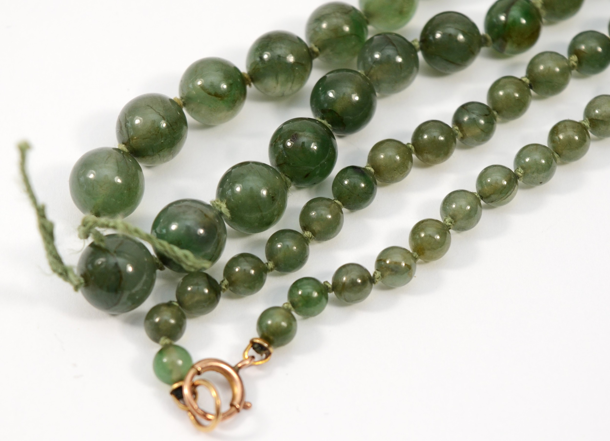 A gold clasped green hard stone graduating beaded necklace, 79cm. - Image 2 of 4