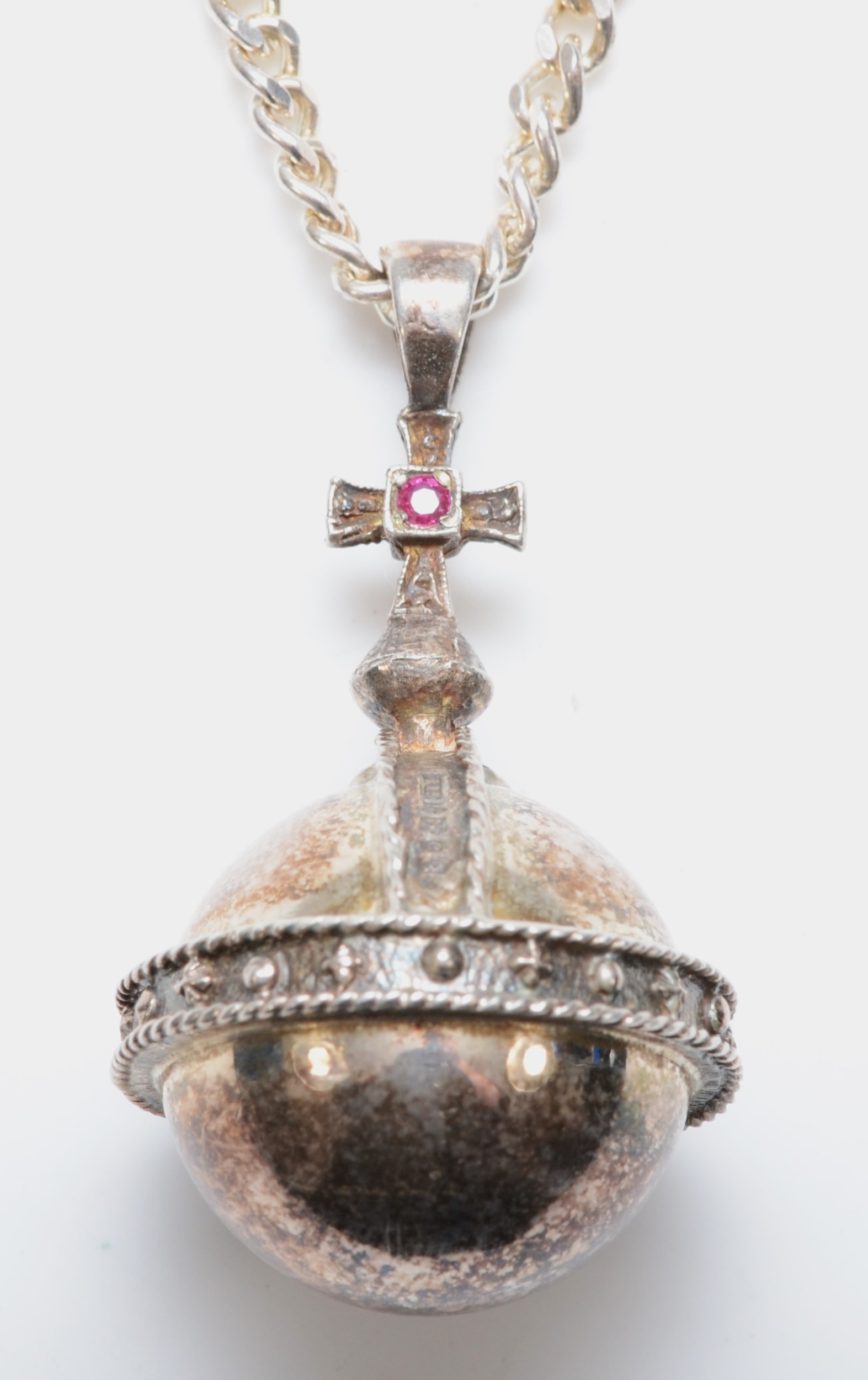 A silver garnet set orb pendant, by P & R Bushell, Birmingham 1977, to celebrate our late Queen’s