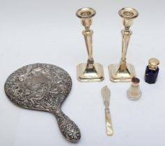 A group of silver items to include a pair of George V silver candle sticks, Birmingham 1918, 18cm,