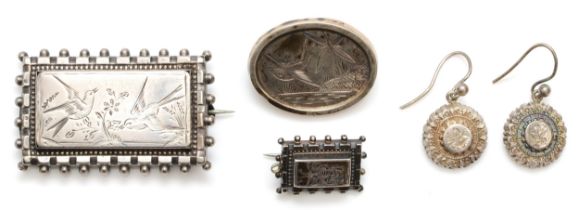 Three Victorian silver brooches with chased bird and insect decoration, largest 44 x 28mm, unmarked,