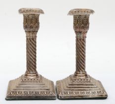 A pair of Victorian silver candle sticks, by Jane Brownett, London 1885, with embossed decoration
