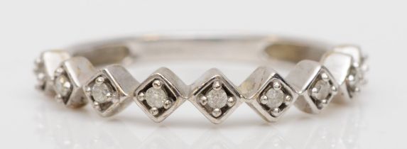 A 9ct white gold brilliant cut diamond half eternity ring, O, 2gm.