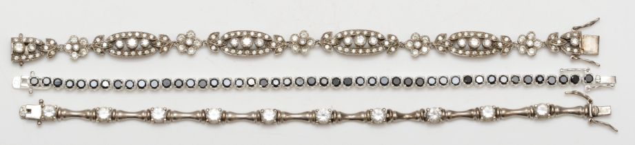 A vintage silver cubic zirconia bracelet, with floral sections, 19.5cm, together with two other