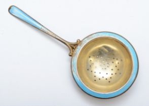 A Scandinavian silver gilt and blue enamel tea strainer, by N.M Thune, 14cm, 29gm.