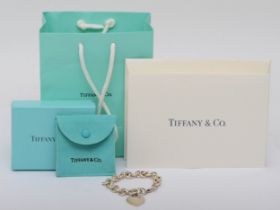 Tiffany & Co., a silver bracelet with heart shaped shaped tag, 18cm, 35gm, original box and bag.