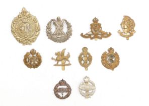 Ten military cap badges to include Artists Rifles and Royal Tank Regiment.