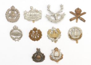Ten military cap badges to include Royal Tank Regiment and Northamptonshire.