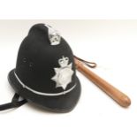 A Northumbria Police helmet, size 7 3/8, together with a wooden truncheon.