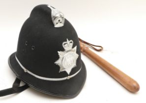 A Northumbria Police helmet, size 7 3/8, together with a wooden truncheon.