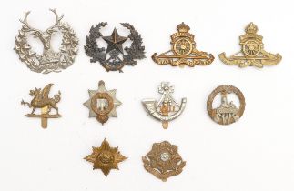 Ten military cap badges to include East Yorkshire and The South Wales Borderers.