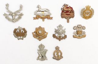 Ten military cap badges, including West Yorkshire and East Yorkshire