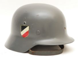 A WWII German M42 steel helmet, with liner and strap, stamped W 3662 and ET64, single decal.