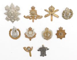 Ten military cap badges to include The Royal Flying Corps and Machine Gun Corps.