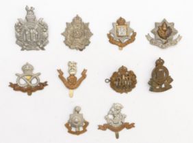 Ten Military cap badges, including West Riding and Royal Sussex
