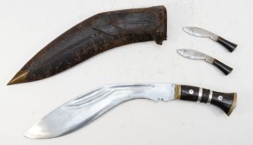 A Military Supply, Syndicat Kukri with two smaller blades, leather scabbard