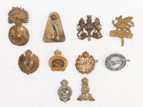 Ten Military cap badge, including The Buffs and Scots Fusiliers.