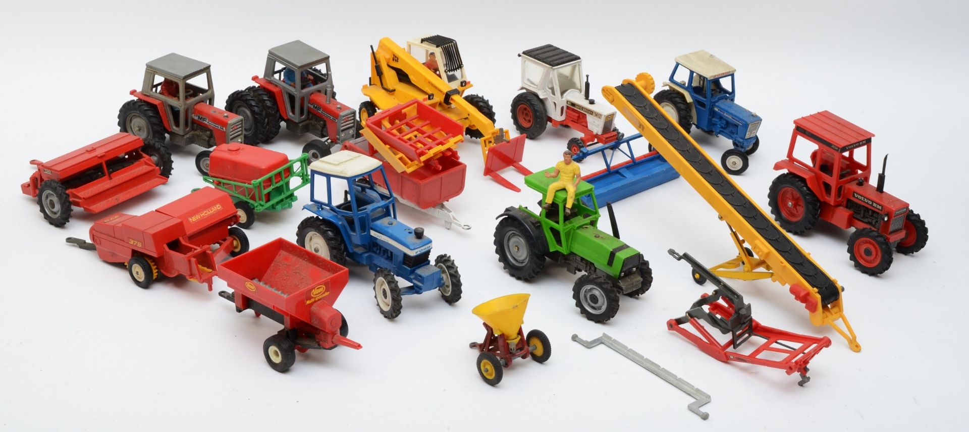 A collection of playworn diecast models of tractors with farming implements by Britains, circa