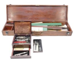 A collection of vintage draftsmans equipment, dividers, rulers and a Castell slide rule, contained