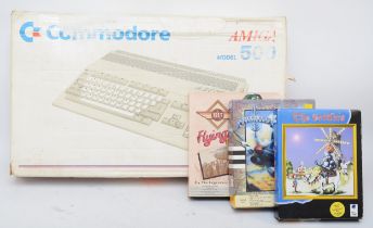A 1980s Amiga 500 computer/games console by C-Commodore, boxed with AC leads, adapter and manuals,